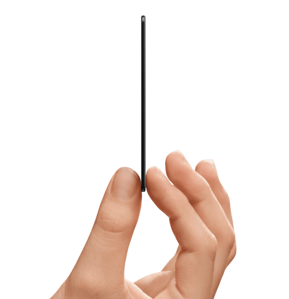 A hand gently holds a thin, black tracking card on its edge, showcasing its slim profile and sleek design.
